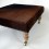 Genuine cowhide footstool 213 with light turned leg and brass castor