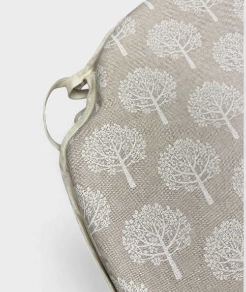 Beige spindle seat pads with a modern white tree design