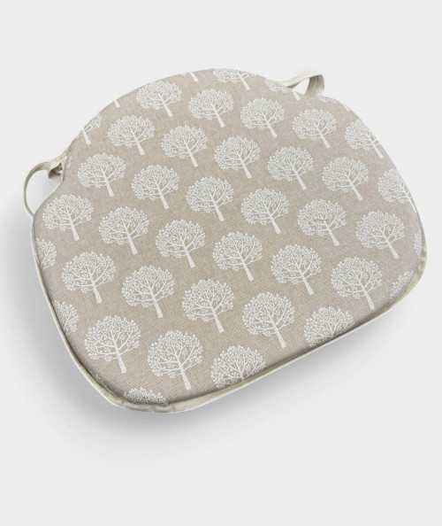 Beige spindle chair pads with a modern white tree design