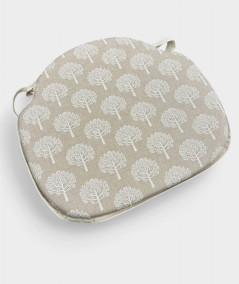 Beige spindle chair pads with a modern white tree design