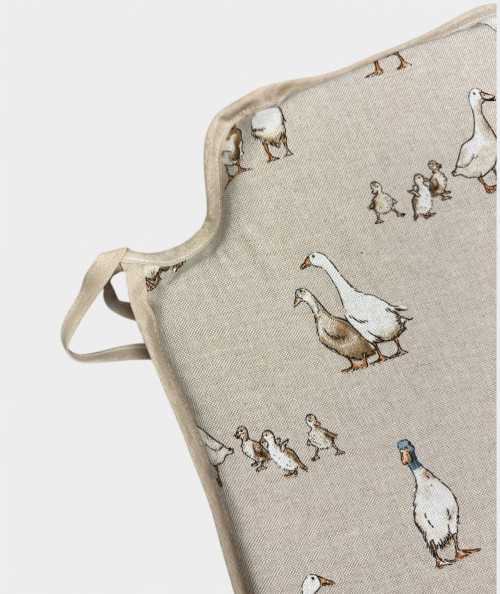 Modern shaped chair pads in a natural linen beige with a modern white duck print