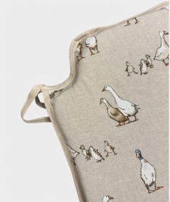 Modern shaped chair pads in a natural linen beige with a modern white duck print