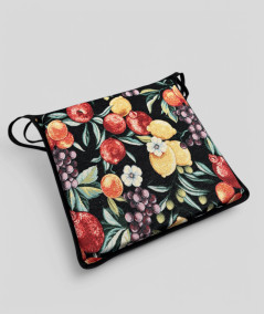 Multi-coloured square chair pads with a modern fruit design on a rich black tapestry base