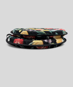 Multicoloured round bistro tapestry chair pads with a modern fruit design on a black base