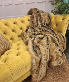 Luxury long-haired beige and brown faux fur sofa throw