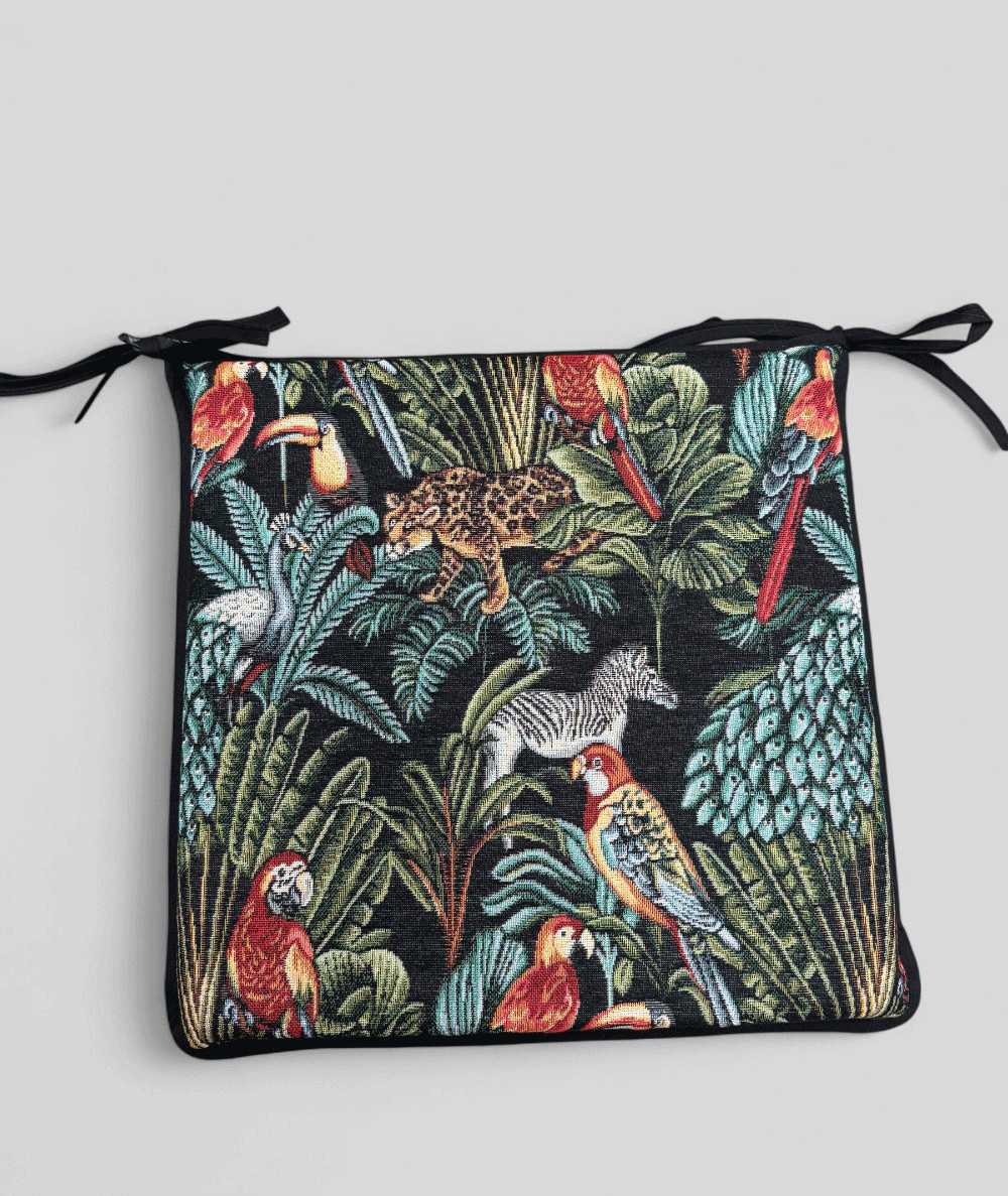 Multi-coloured square chair pads with a modern rainforest design on a rich black tapestry base